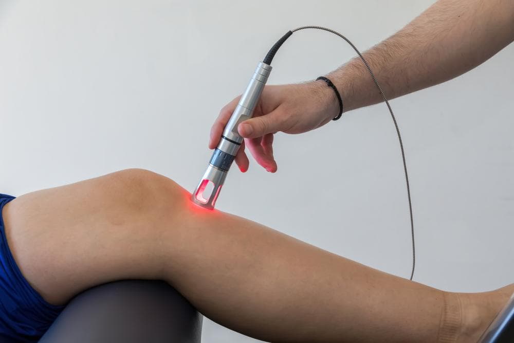 Class 4 laser therapy treatment on a patient's knee