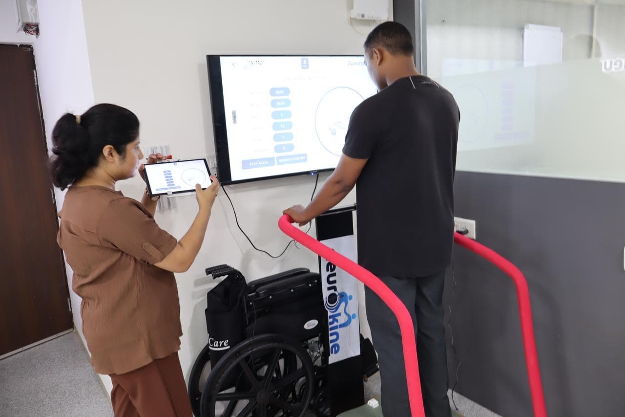 Patient using robotic rehabilitation tools with therapist guidance